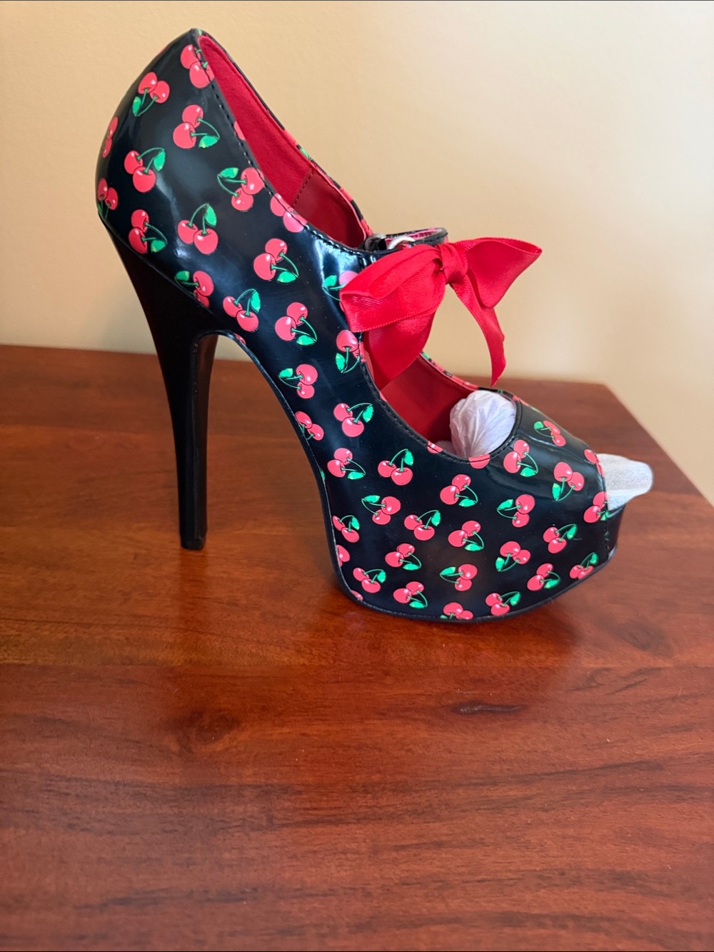 Pleaser’s Pin Up Couture Black Cherry-Print Peep Toe Platform Heel with Red Bow
